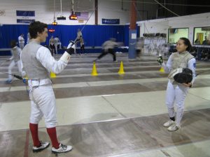 Junior Cooper Jackson fences with Day eighth grader Tiffany Luong last Tuesday at the Boston Fencing Club in Waltham.