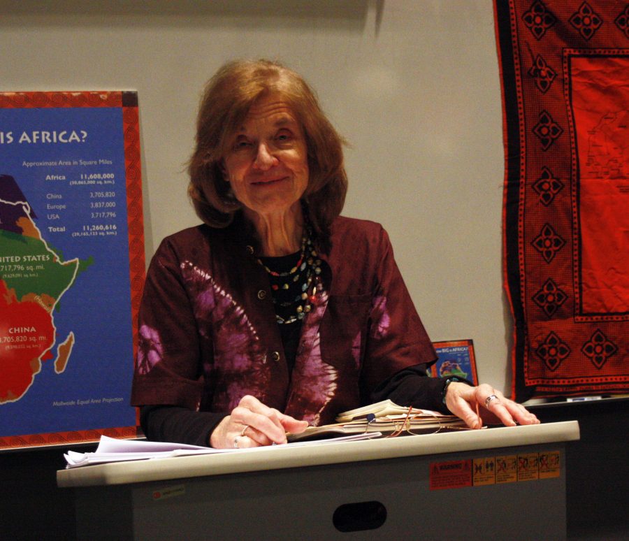 Former teacher Anne Serafin presents a poetry anthology written by 16 African woman during the Huntington Lecture yesterday. 