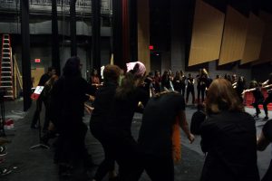 The cast of Freshman Cabaret warms up to get ready for rehearsal. Photo by Robin Donohoe.