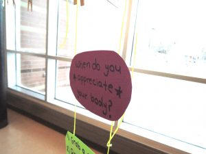 Students hung neon note cards with the answer to this question on clotheslines outside the auditorium. 