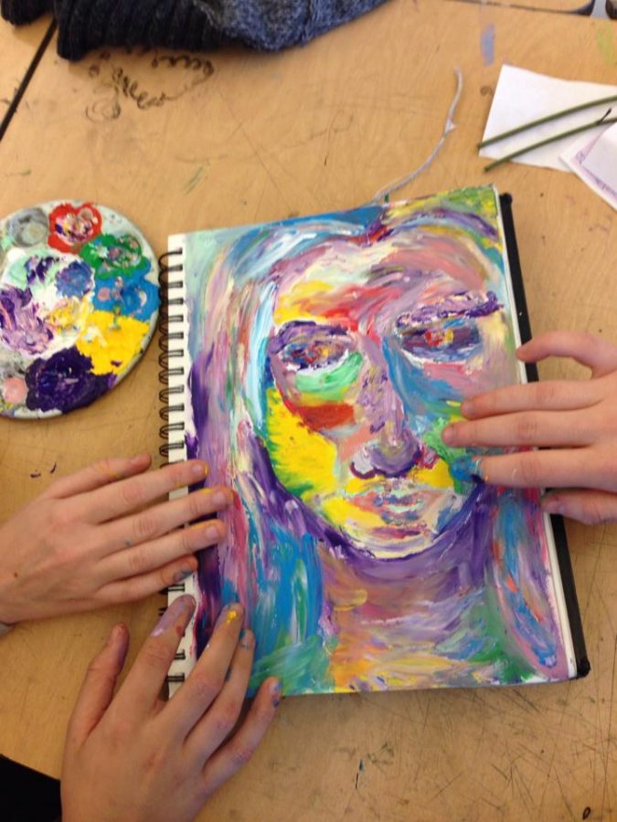 Sophomores Jessica Pullen-Schmidt, Julia Dwyer, and Naomi Forman-Katz work on a finger painting in Julia Dwyers sketchbook, which will be on display during Art Morning.
