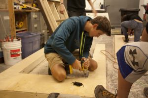 Stage Crew: Freshman Campbell Rogers works on a set piece for “Brighton Beach Memoirs” Monday, Sept. 15. Graphic by Leah Budson.