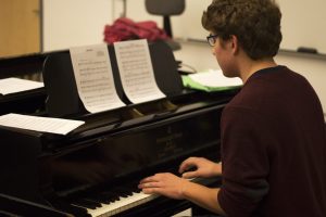 This year's pianist, Brendan King, rehearses one of the songs with the cast of Freshman Cabaret.