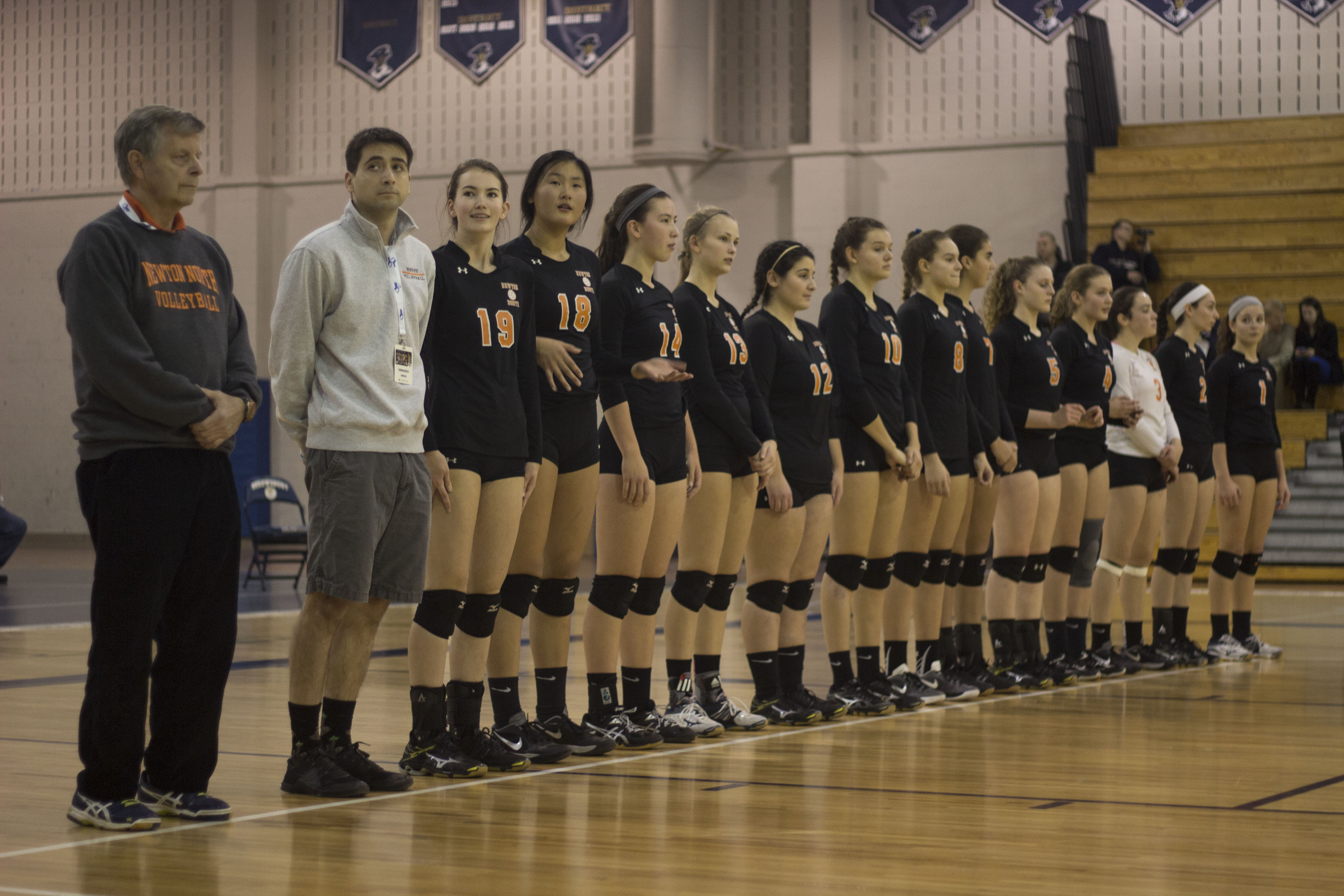 The girls varsity volleyball team stands in line at the beginning of the state finals match against Barnstable Saturday, Nov. 19. Photo by Josh Shub-Seltzer.