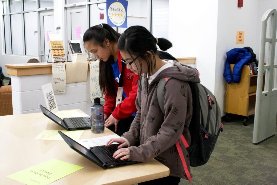 Freshmen Jolie Liu and Nicole Ou sign-in to the library during a lunch block free. 