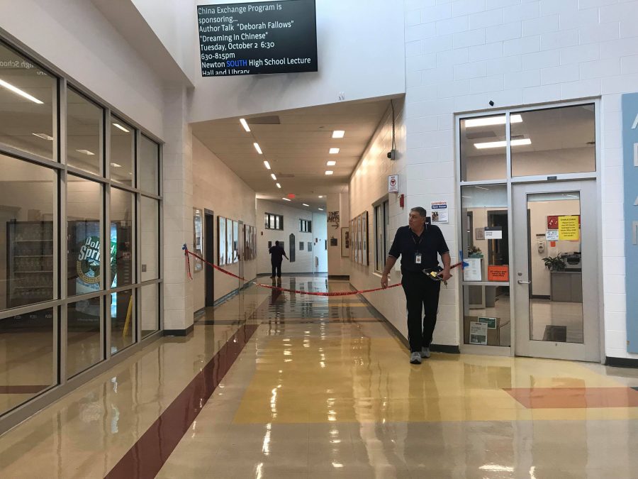 Custodians and guidance aides block the arts corridor and courtyard due to the flood. (Photo by Joelle Sugianto)