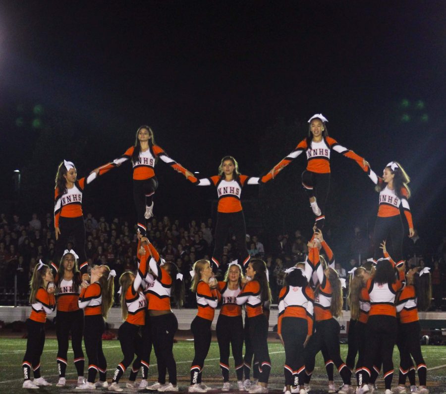 Cheerleading+performs+a+pyramid+stunt+at+Friday+Night+Lights.+%28Photo+by+Joelle+Sugianto%29