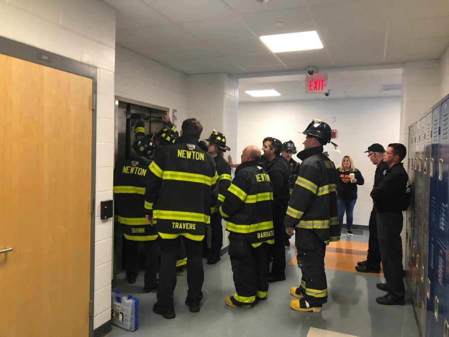 Firefighters work to free six students stuck inside elevator three. (Photo by Sophie Murthy)
