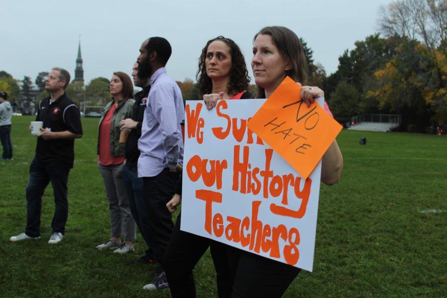 Teachers held signs in support of current history curricula during a standout last October. (Photo by Joelle Sugianto)
