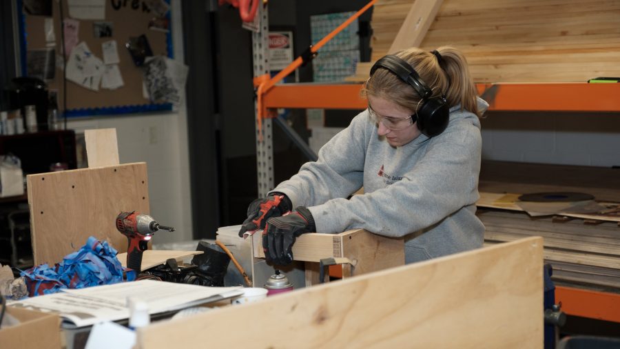 Senior Leah Lakomski works to create a set piece for Rock of Ages Wednesday, March 6. (Photo by Ian Dickerman)