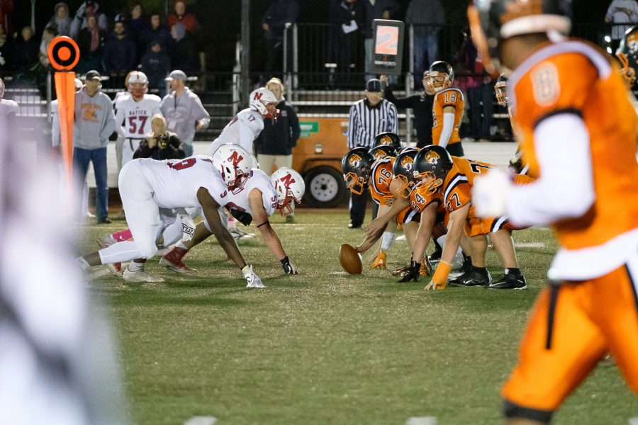 Football faces off against Natick in the annual Friday Night Lights game, Friday, Oct. 18. (Photo by Ian Dickerman)