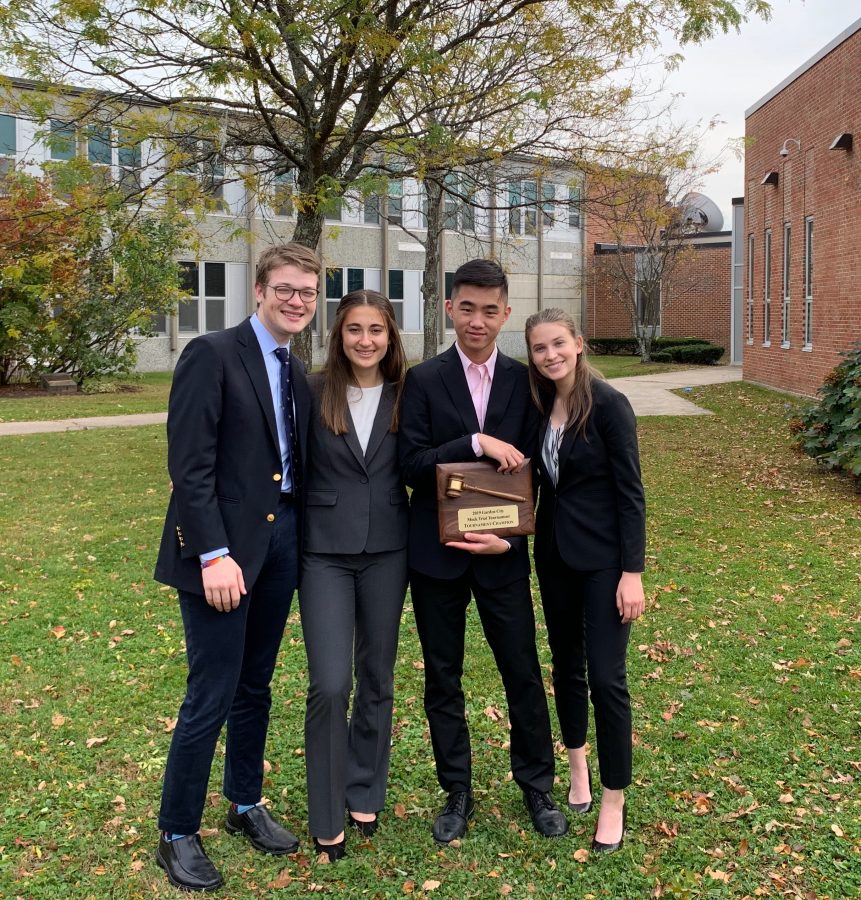 Seniors Claire Gardner, Sonya Gelfand, and Henry Isselbacher and junior Kevin Wu pose with the Garden City award. Gardner, Gelfand, and Wu are captains of mock trial. (Photo courtesy of Claire Gardner)
