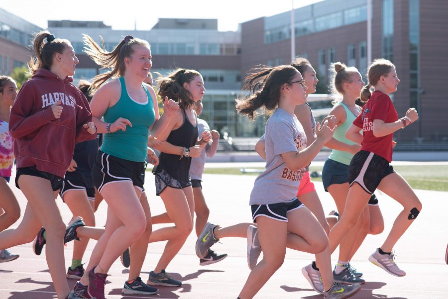 Members of the cross country team practice at Dickinson Stadium on Tuesday, Aug. 27. (Photo by Ella Bailey)