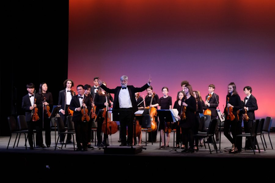 The Orchestra, directed by music teacher Adam Grossman, stands for applause. (Photo by Ian Dickerman)