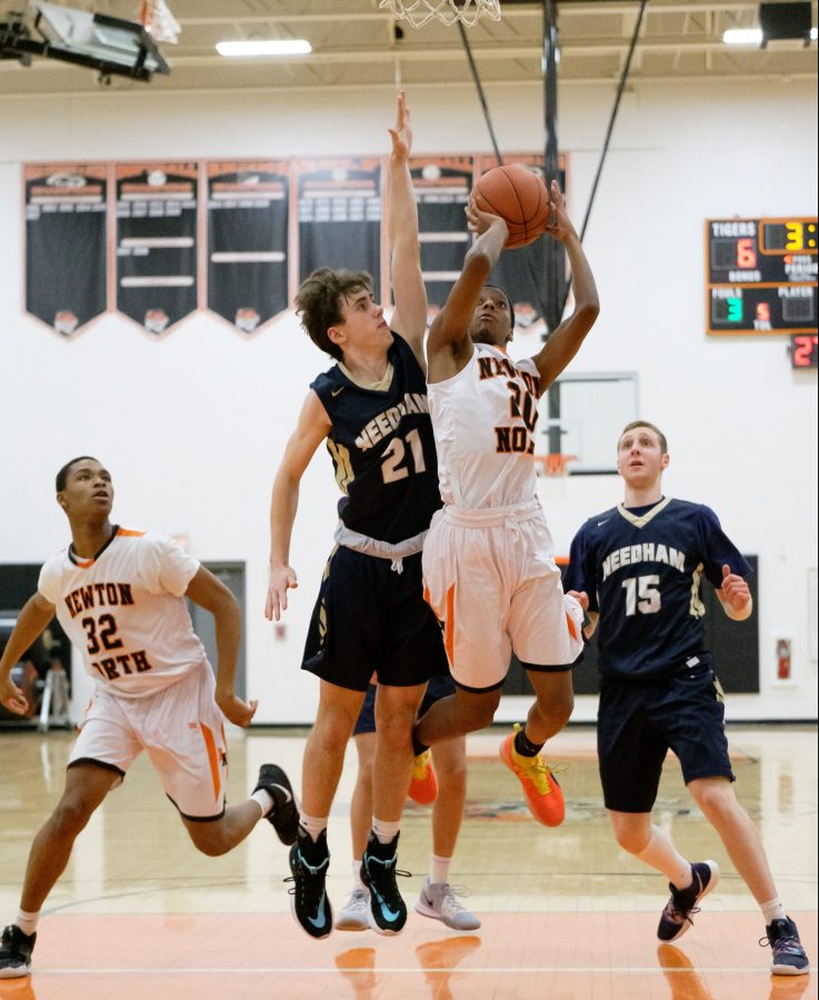 Senior Shawn Brothers goes for a layup against Needham in North's home loss Tuesday, Feb. 11.  (Photo by Ian Dickerman)