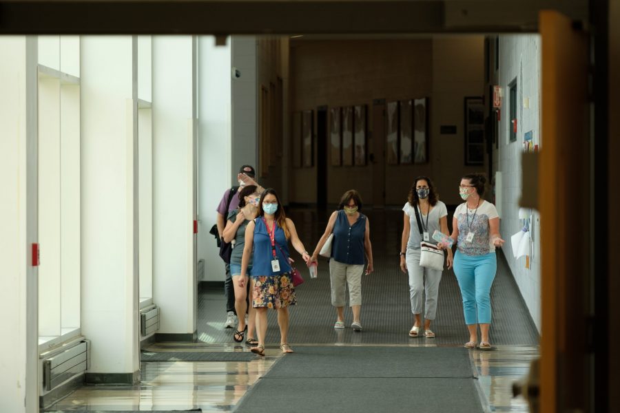 Faculty members walk down the hallway towards the theatre entrance Wednesday, Sept. 9. (photo by Ian Dickerman)