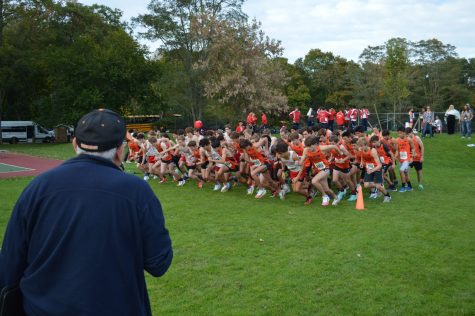 Coach Lou Pearlman looks on as his runners explode off the starting line Wednesday, Oct. 20 at Cold Spring Park. (Photo by Andrew Hirshberg)