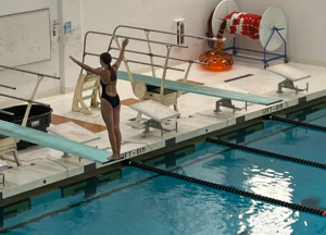 Junior Lila Tulimieri lines up to perform an inward dive. 