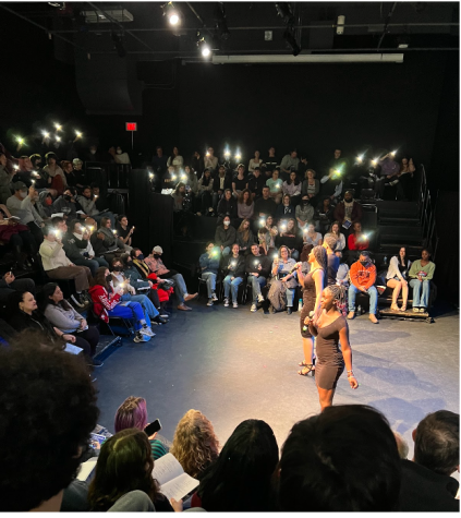 Audience members begin to wave lights during All Of Me.