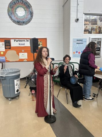 Sophomore Aly Tahoun and freshman Maialen Alawam play the drums and sing middle-eastern tunes outside the cafeteria Friday, March 10.