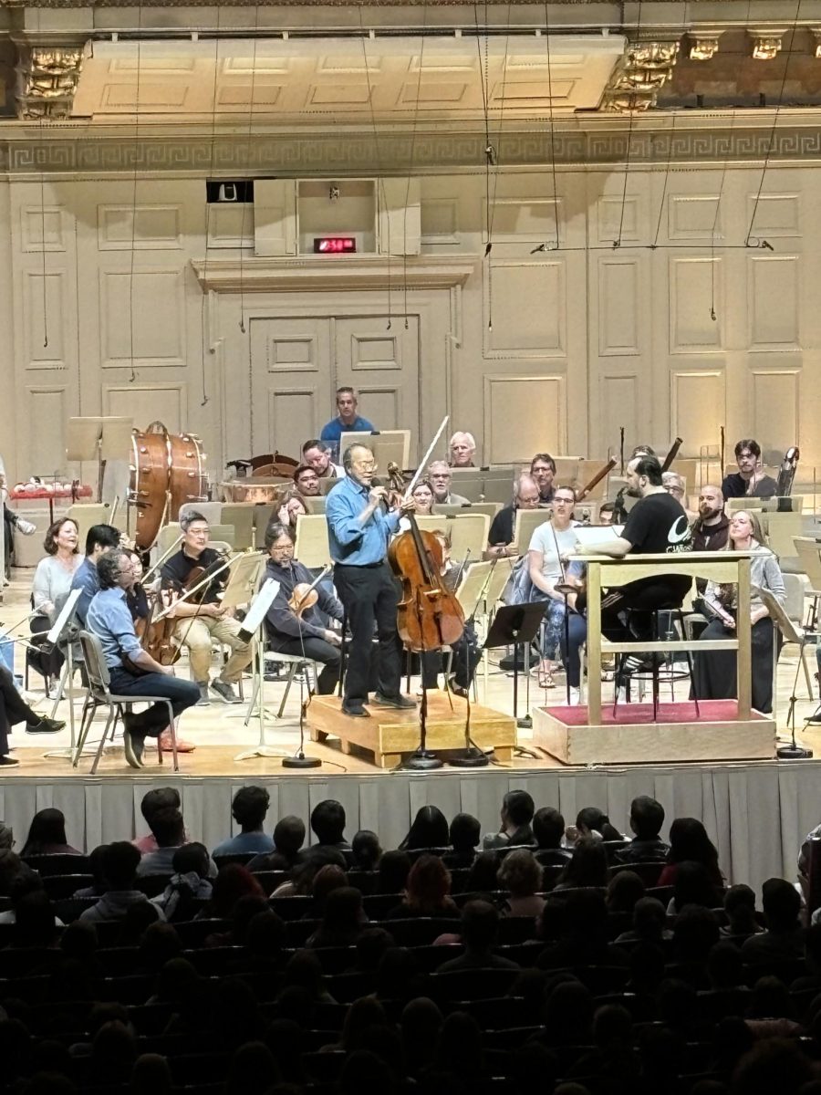 Yo-Yo Ma speaks to the audience at a Boston Symphony Orchestra open rehearsal attended by Norths band and orchestra, Thursday, Oct. 12.