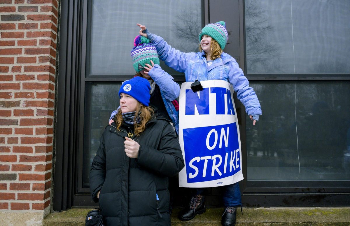 Inclusion specialist Kate Woodford and her two daughters visit the Education Center to attend the union protest Wednesday, Jan. 24.