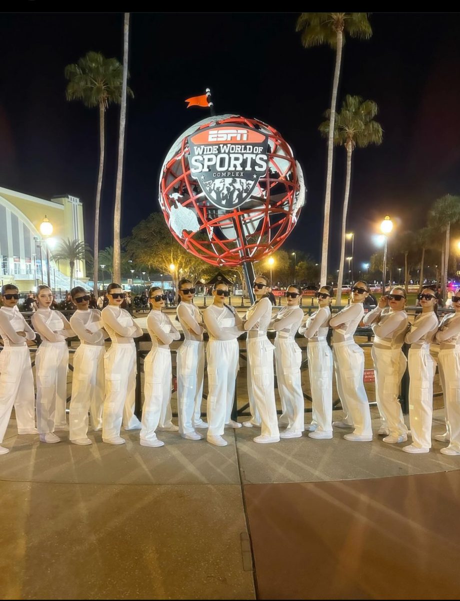Members of the Dance team pose in front of the ESPN globe for picture after competing, Saturday, Feb. 2. 