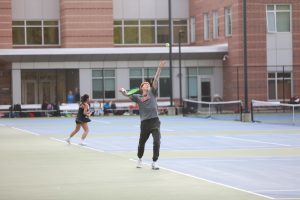 Senior Lochlan Seth prepares to serve ball, Monday, May 13. 