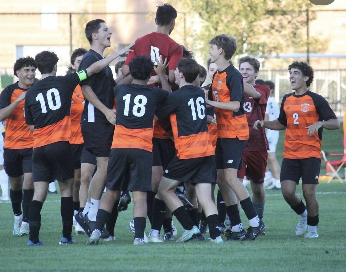 The team celebrates goalie Gabino Talisayon after a save, Tuesday Sept. 10.