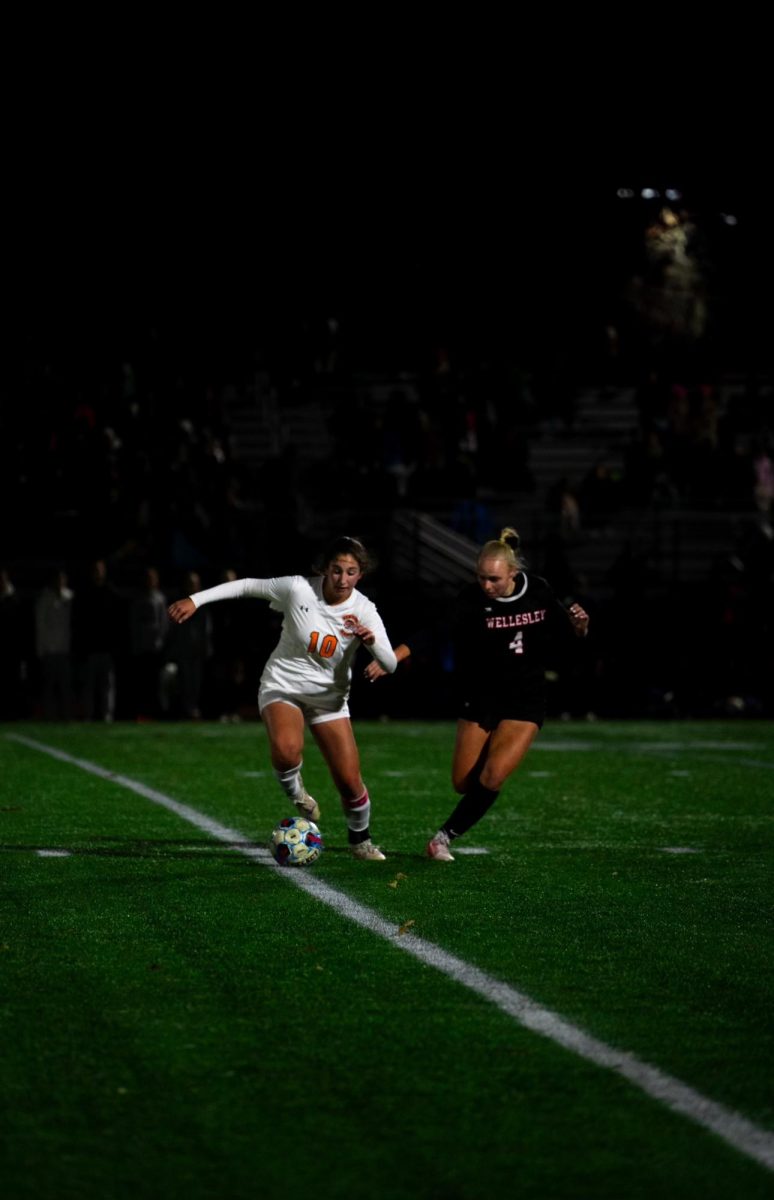 Senior Vivi Kritzer dribbles past Wellesley defender Tuesday, Nov. 12. 