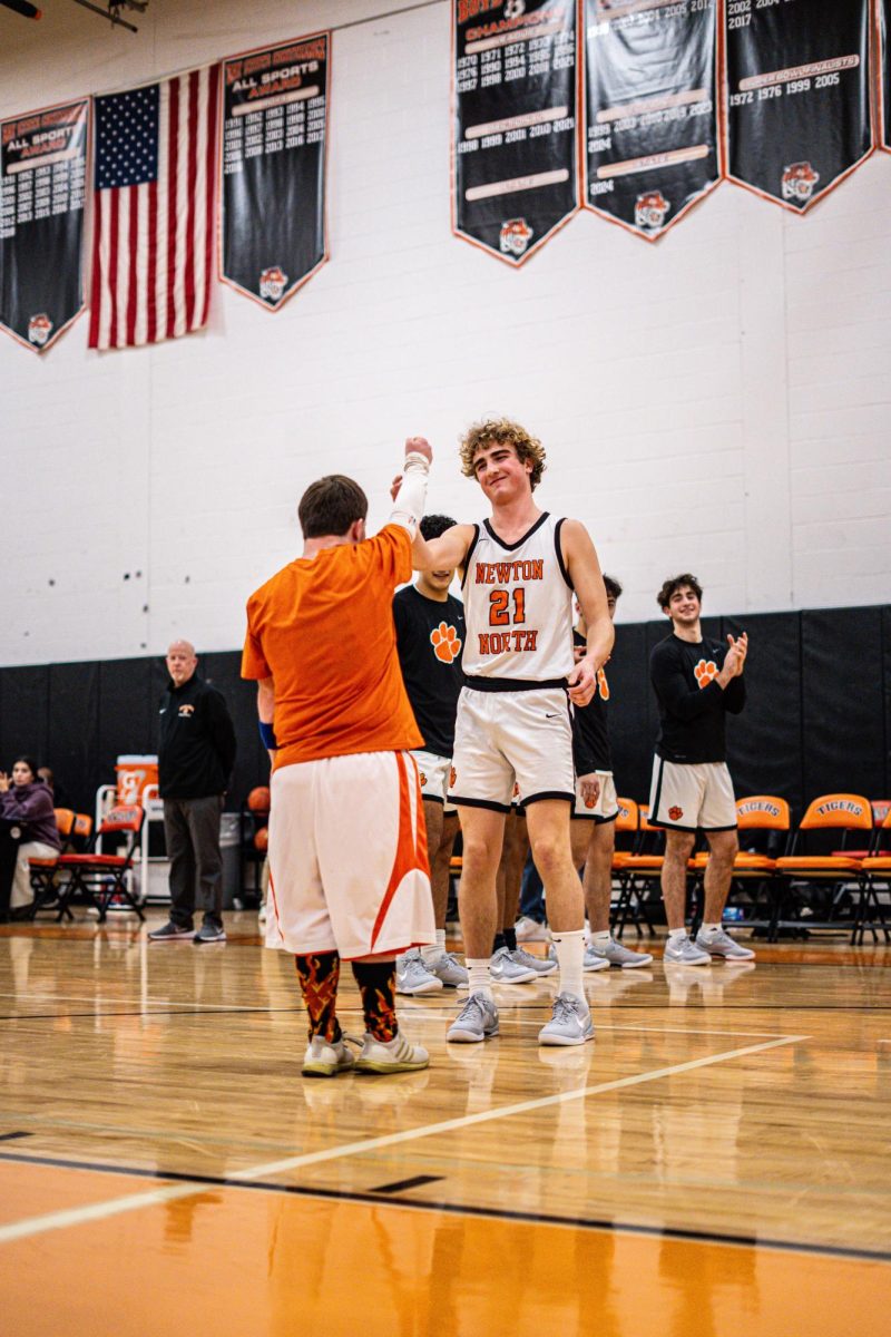 Senior captain Nicky Spinelli completes his starting handshake before boys' basketball faces Framingham Friday, Dec. 13. 