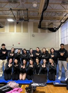 Members of the gymnastics team pose after their record-breaking win Tuesday, Jan. 7. 