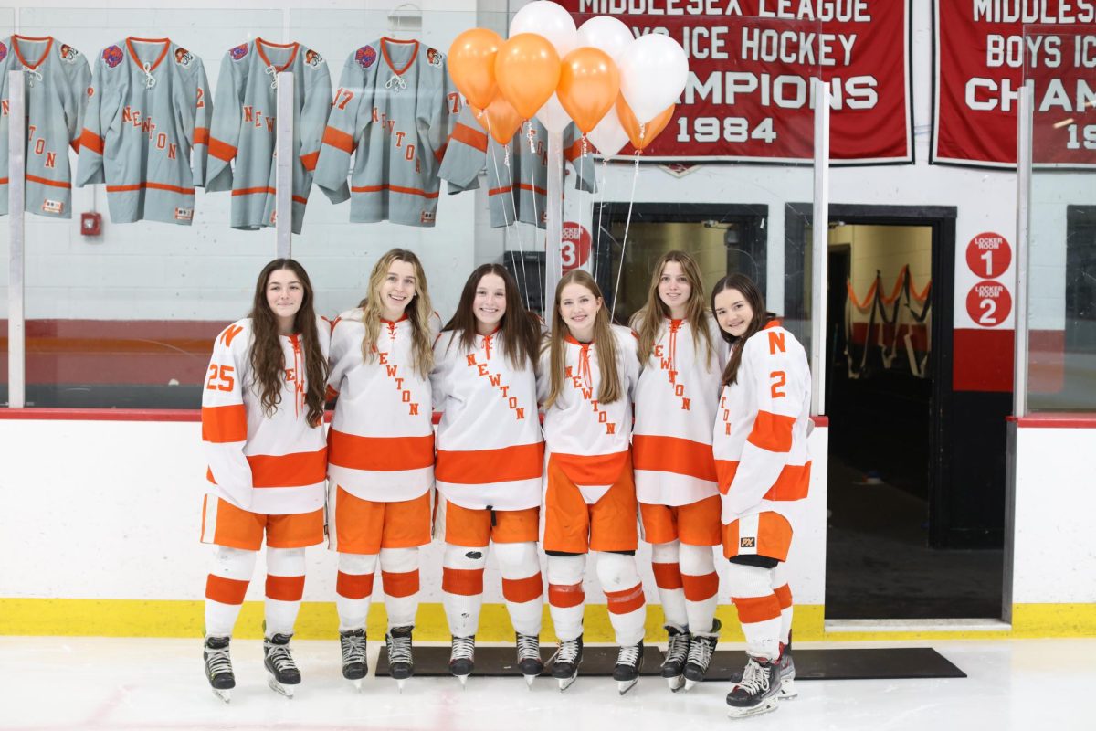 The team's seniors pose for a picture at pre-game celebrations Saturday, Feb. 8.