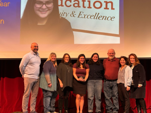 Donnellan accepts annual CTE award while standing with CTE faculty Thursday, Jan. 30.

