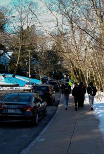 Students walk to school from their cars parked on Hull Street Thursday, Feb. 13. 