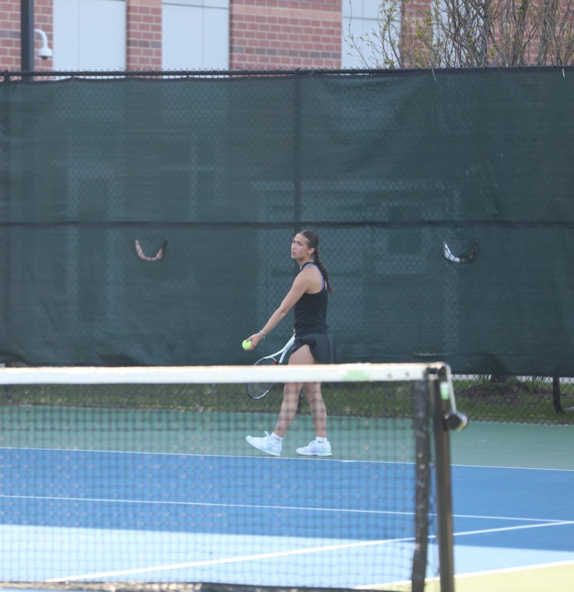 Junior Roxy Feldman prepares to serve Monday, April 28. 