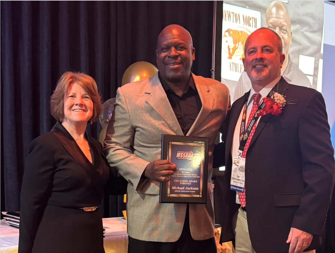 Athletic Director Mike Jackson poses with his award alongside District 7 Councilors, Friday, March 28. 