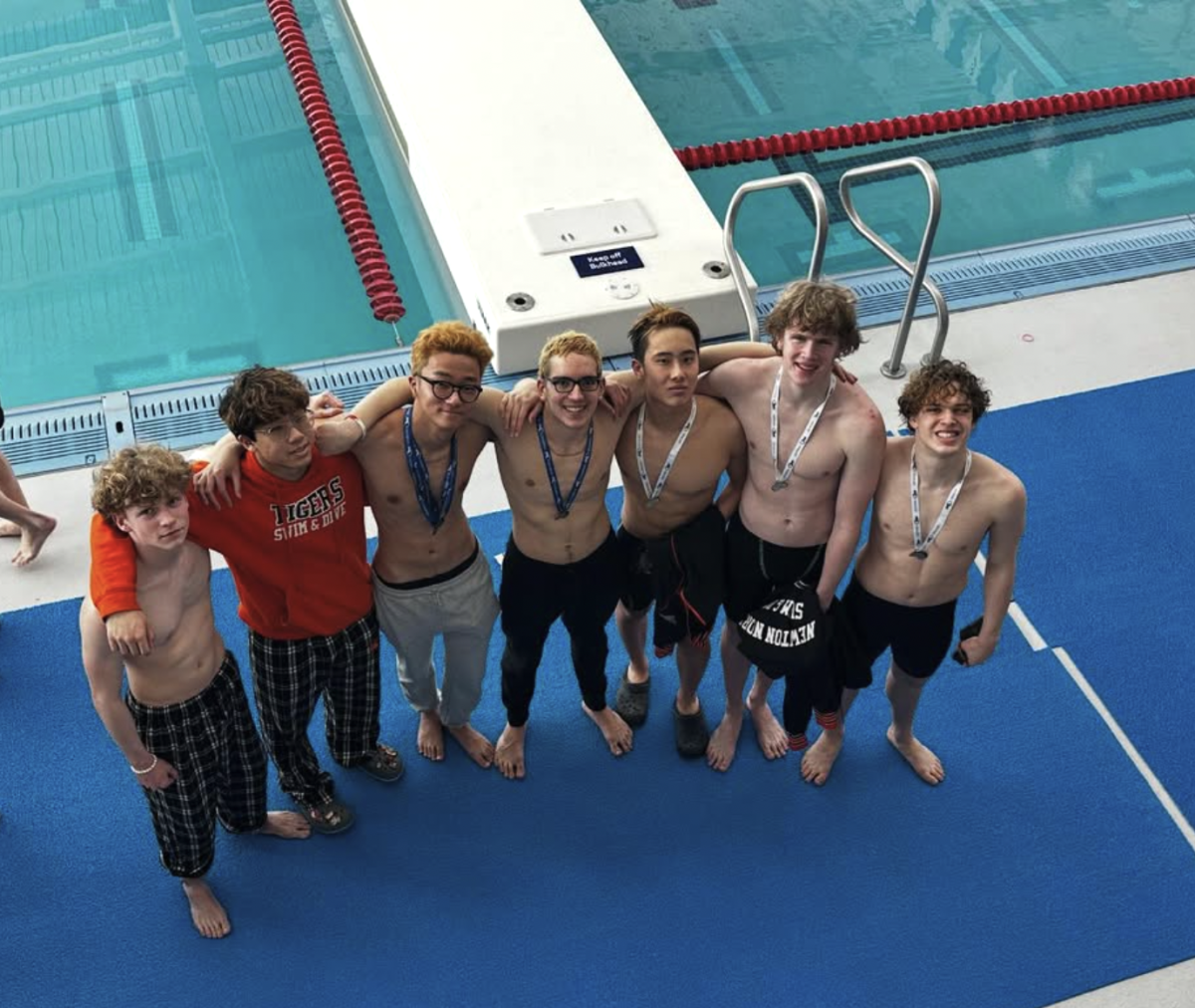 Caputo and his teammates embrace after a hard-earned 3rd place finish at States, Sunday, Feb. 23. 