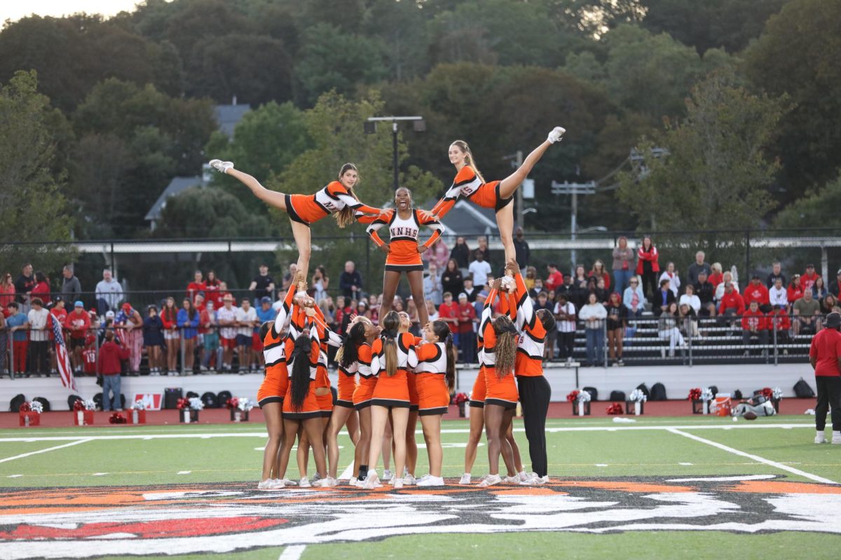 Cheerleading performs a stunt at Friday Night Lights, Friday, Sept. 12.
