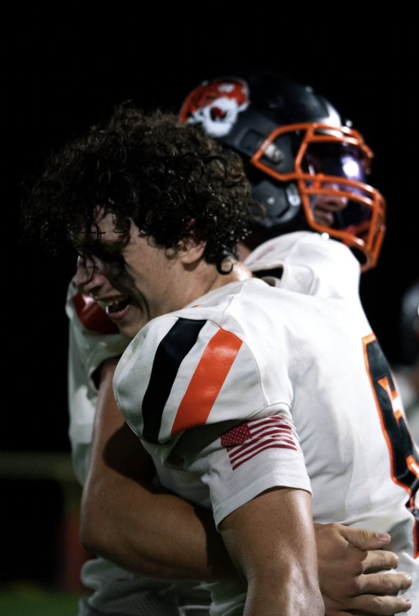 Senior Jacob Goodwin embraces a teammate after a touchdown, Thursday, Oct. 10.