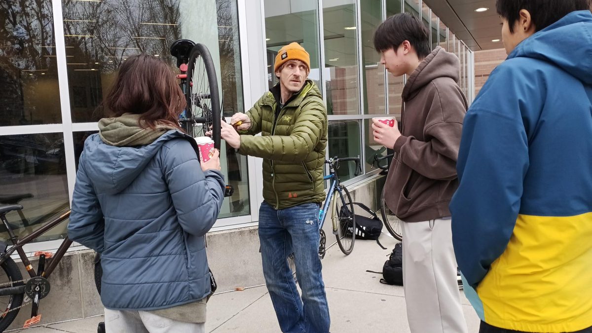 Door To Door repair co-owner Jamison Bourque instructs North students on bike repair strategies, Friday Nov. 21. 