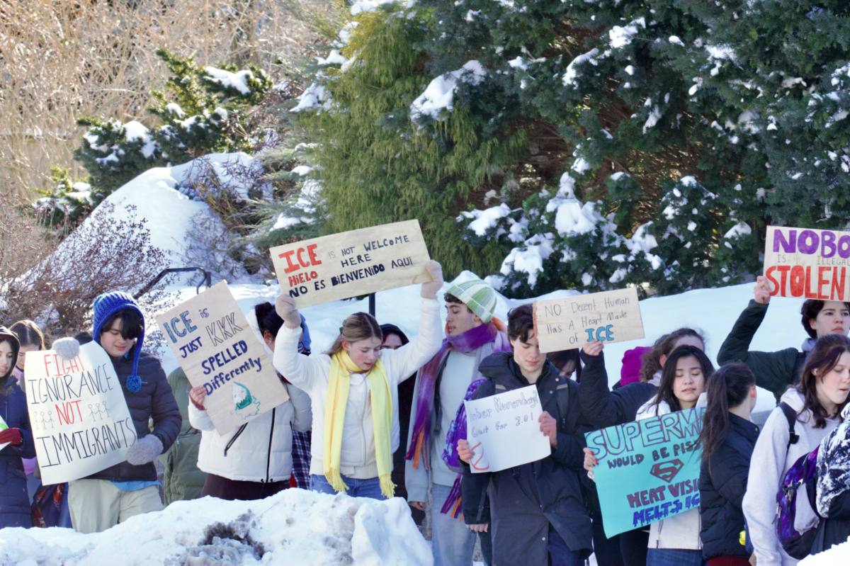 North students carry signs during walkout in protest of ICE.